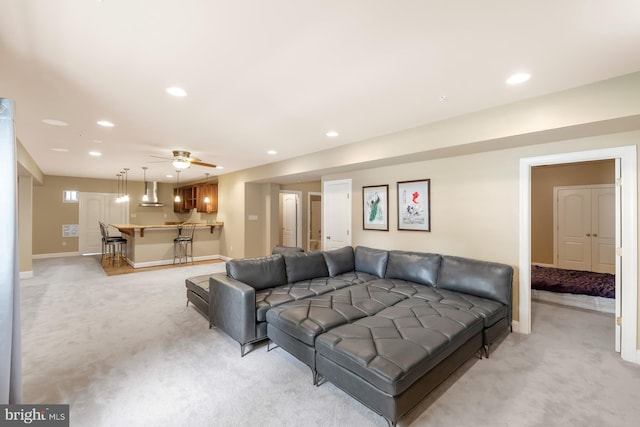 living room with light colored carpet, recessed lighting, baseboards, and ceiling fan