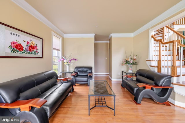 living area with wood finished floors, ornamental molding, baseboards, and stairs