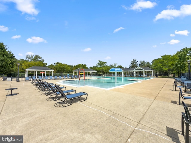 community pool featuring a gazebo and a patio