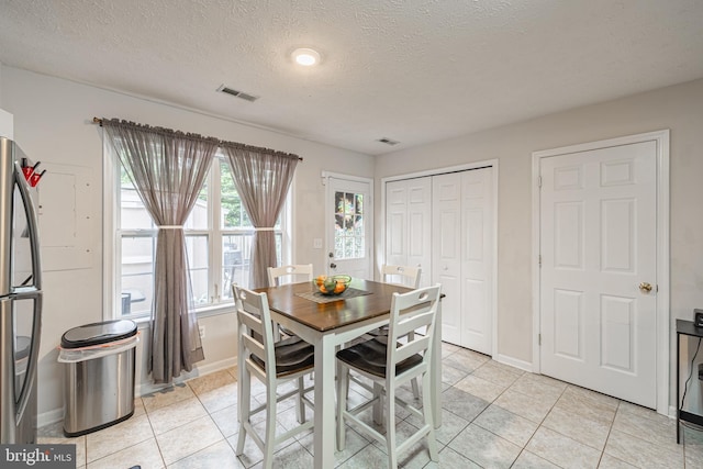 9910 Warwick Pl, Fredericksburg, VA 22408 - dining room featuring light tile patterned floors, baseboards, and a textured ceiling