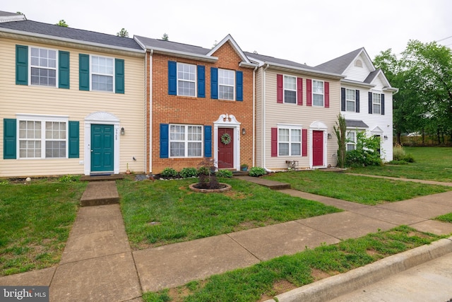 9910 Warwick Pl, Fredericksburg, VA 22408 - townhome / multi-family property featuring a front yard and brick siding