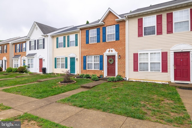 9910 Warwick Pl, Fredericksburg, VA 22408 - townhome / multi-family property featuring a front yard and brick siding