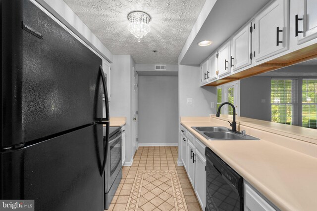 1476 Greenbriar Cir Unit 1-1476, Pikesville, MD 21208 - kitchen featuring black appliances, a sink, light tile patterned flooring, light countertops, and white cabinetry