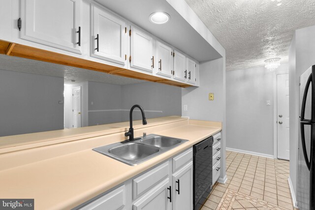1476 Greenbriar Cir Unit 1-1476, Pikesville, MD 21208 - kitchen featuring black appliances, a sink, white cabinetry, light countertops, and a textured ceiling