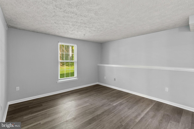 1476 Greenbriar Cir Unit 1-1476, Pikesville, MD 21208 - unfurnished room with dark wood-style flooring, a textured ceiling, and baseboards