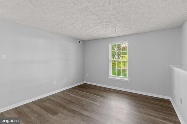 1476 Greenbriar Cir Unit 1-1476, Pikesville, MD 21208 - unfurnished room with wood finished floors, a textured ceiling, and baseboards