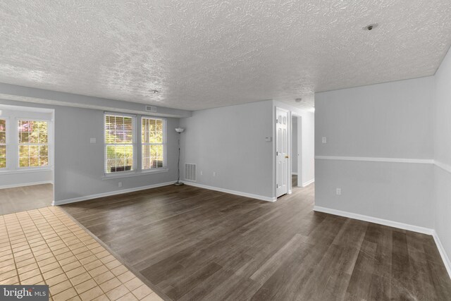 1476 Greenbriar Cir Unit 1-1476, Pikesville, MD 21208 - empty room featuring dark wood finished floors, a textured ceiling, and baseboards