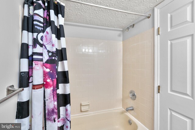 1476 Greenbriar Cir Unit 1-1476, Pikesville, MD 21208 - full bathroom featuring a textured ceiling and shower / tub combo with curtain