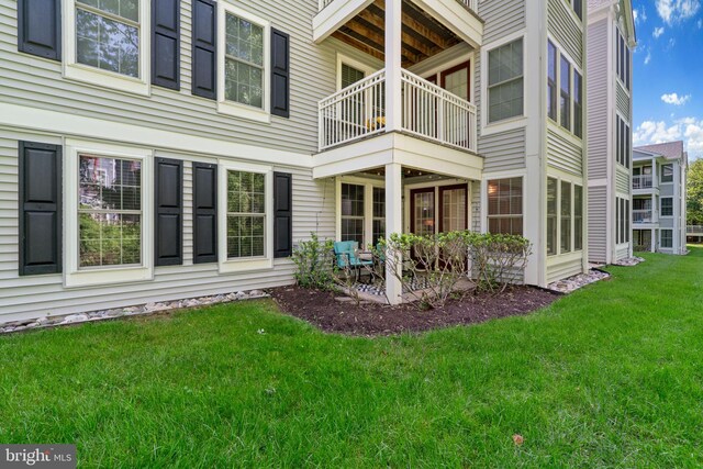 1476 Greenbriar Cir Unit 1-1476, Pikesville, MD 21208 - rear view of property with a balcony and a lawn