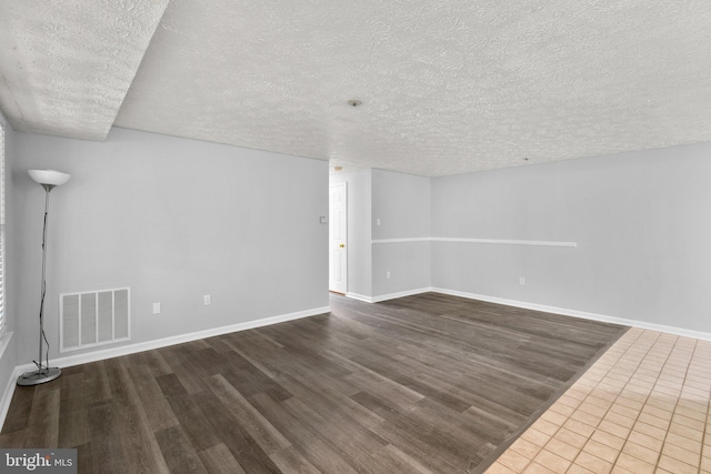 1476 Greenbriar Cir Unit 1-1476, Pikesville, MD 21208 - unfurnished room featuring a textured ceiling, wood finished floors, and baseboards
