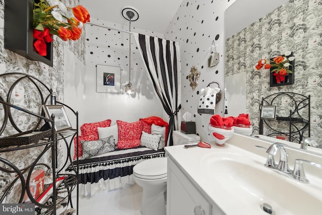 bathroom featuring toilet, wallpapered walls, vanity, and tile patterned floors