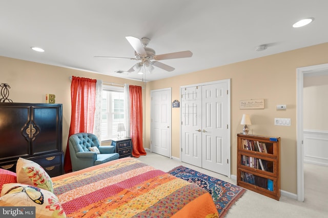 bedroom with light carpet, two closets, baseboards, recessed lighting, and ceiling fan