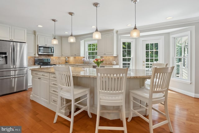 6107 Hour Hand Ct, Columbia, MD 21044 - kitchen with appliances with stainless steel finishes, light wood-type flooring, backsplash, white cabinetry, and recessed lighting
