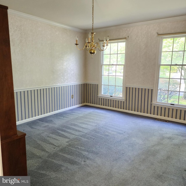 empty room featuring a chandelier, carpet, ornamental molding, and wallpapered walls