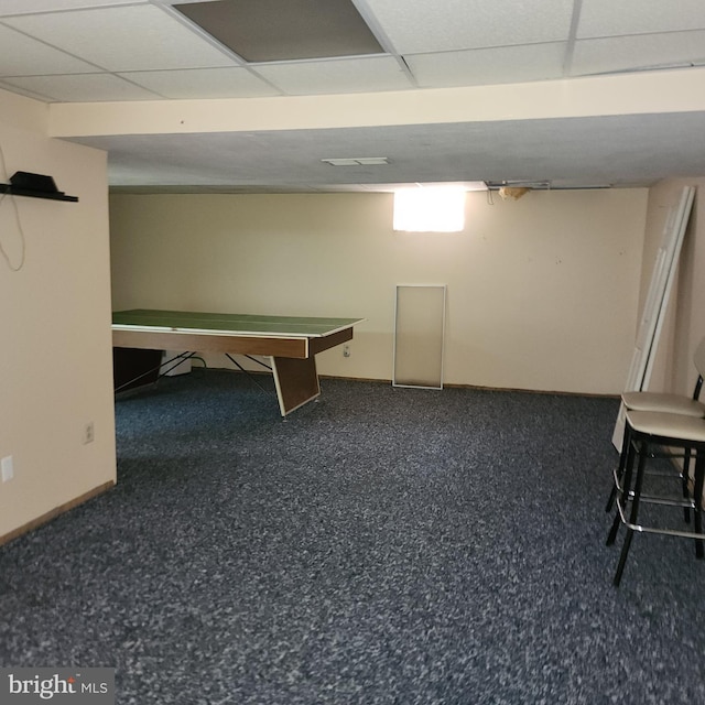 playroom featuring a paneled ceiling and baseboards