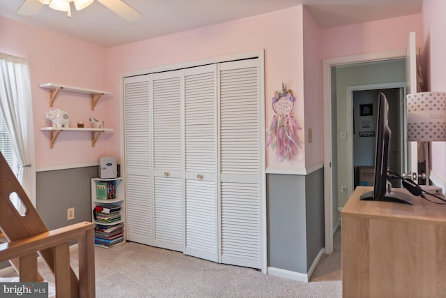 bedroom with light carpet, a closet, and ceiling fan