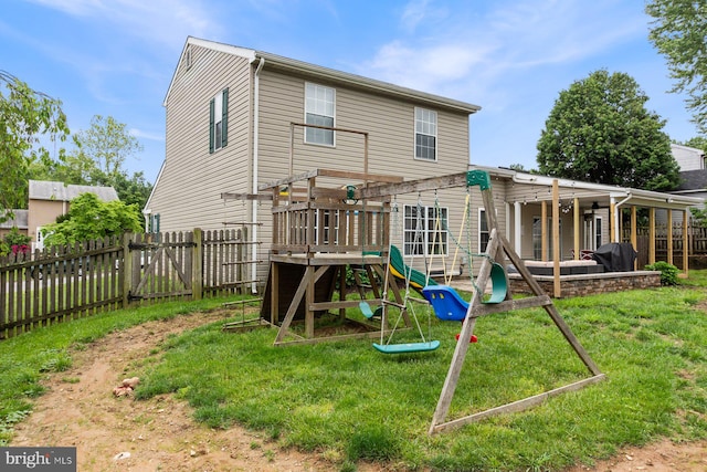 back of house with a playground and a pergola