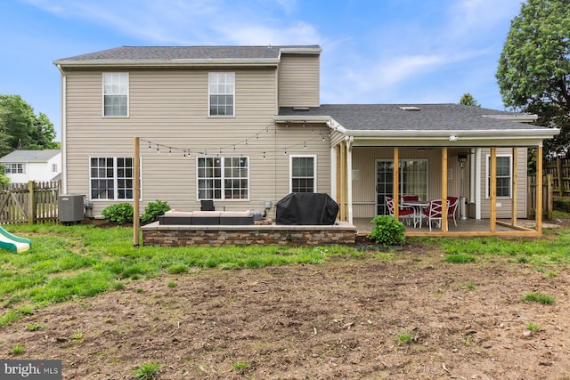 rear view of house with an outdoor hangout area, fence, central AC unit, and a patio