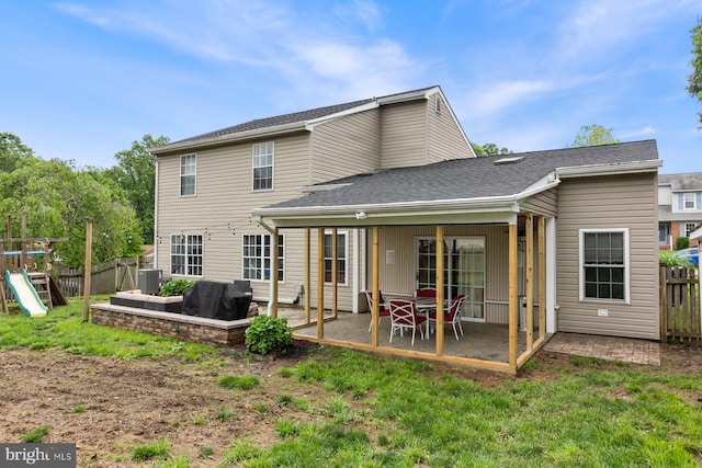 back of house featuring central air condition unit, a patio area, and a playground
