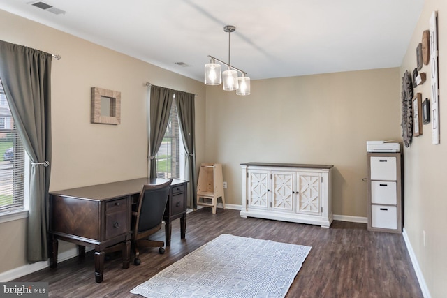 office space with wood finished floors and baseboards