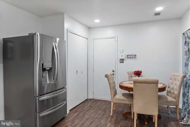 dining room with dark wood-style flooring and recessed lighting