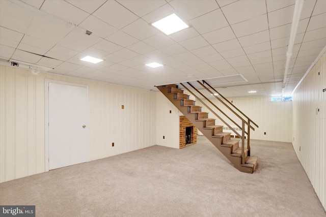 finished below grade area with carpet flooring and stairs