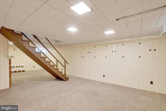 finished basement with carpet flooring and stairway