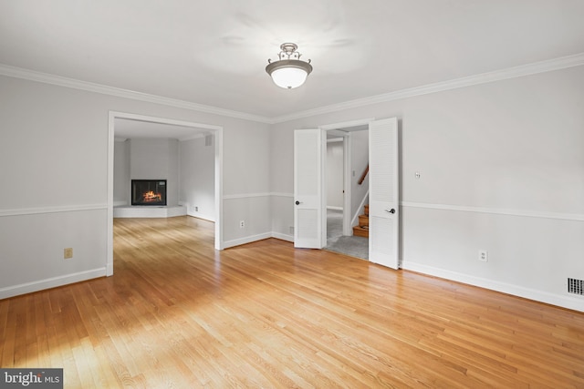5817 Dawes Ave, Alexandria, VA 22311 - unfurnished room featuring light wood finished floors, stairs, crown molding, and a fireplace