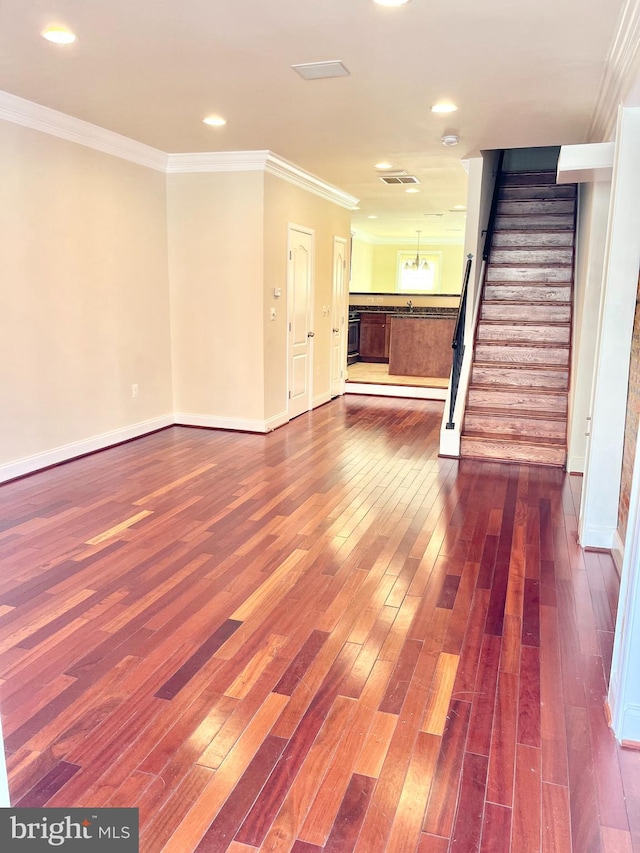 unfurnished living room with stairs, dark wood-style floors, ornamental molding, baseboards, and recessed lighting