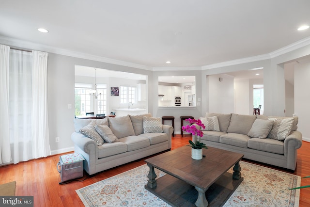 13626 Sylvan Bluff Dr, Leesburg, VA 20176 - living area featuring ornamental molding, light wood-type flooring, a chandelier, and recessed lighting