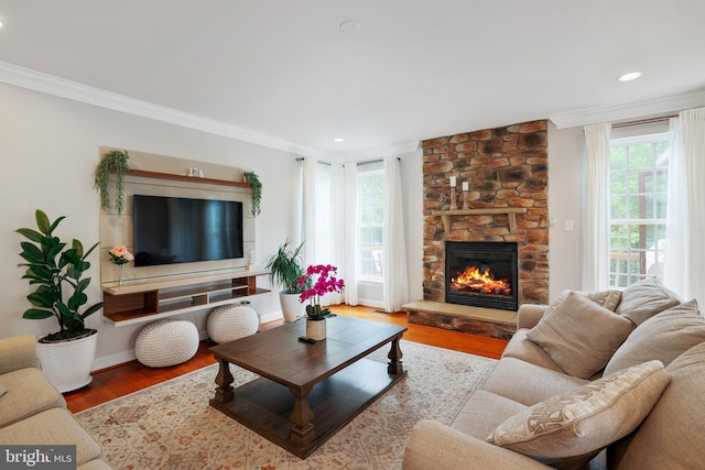 13626 Sylvan Bluff Dr, Leesburg, VA 20176 - living area with healthy amount of natural light, ornamental molding, a fireplace, wood finished floors, and recessed lighting