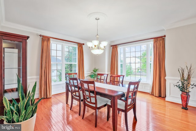 13626 Sylvan Bluff Dr, Leesburg, VA 20176 - dining room featuring ornamental molding, a chandelier, light wood-type flooring, and a wainscoted wall