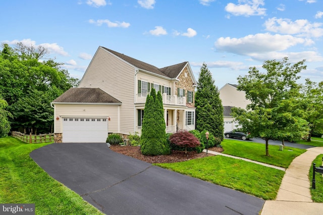 13626 Sylvan Bluff Dr, Leesburg, VA 20176 - view of front of property featuring a balcony, asphalt driveway, stone siding, an attached garage, and a shingled roof