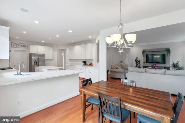 13626 Sylvan Bluff Dr, Leesburg, VA 20176 - dining space featuring a chandelier, recessed lighting, and light wood finished floors