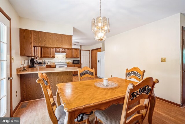 13245 Croom Rd, Upper Marlboro, MD 20772 - dining room with light wood-style floors, a chandelier, and baseboards