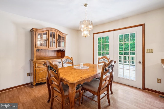 13245 Croom Rd, Upper Marlboro, MD 20772 - dining area with light wood finished floors, baseboards, and a chandelier