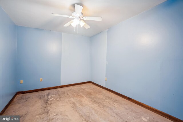 13245 Croom Rd, Upper Marlboro, MD 20772 - unfurnished room featuring unfinished concrete flooring, baseboards, and a ceiling fan
