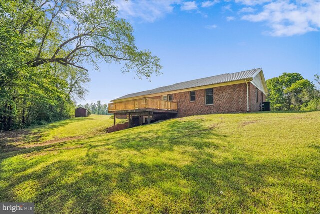 13245 Croom Rd, Upper Marlboro, MD 20772 - back of house with a deck, a lawn, brick siding, metal roof, and cooling unit