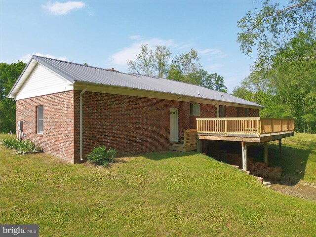 13245 Croom Rd, Upper Marlboro, MD 20772 - back of house featuring a wooden deck, a yard, metal roof, and brick siding