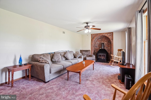 13245 Croom Rd, Upper Marlboro, MD 20772 - carpeted living room featuring a wood stove and ceiling fan