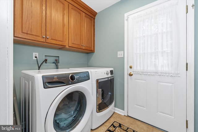 laundry area featuring cabinet space, separate washer and dryer, baseboards, and light tile patterned flooring