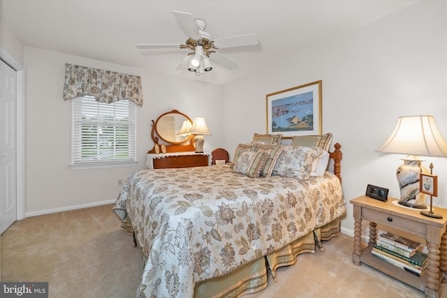 carpeted bedroom with baseboards and a ceiling fan