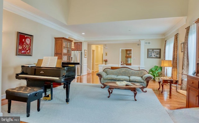 44458 Maltese Falcon Sq, Ashburn, VA 20147 - living room with ornamental molding, light wood finished floors, decorative columns, recessed lighting, and baseboards