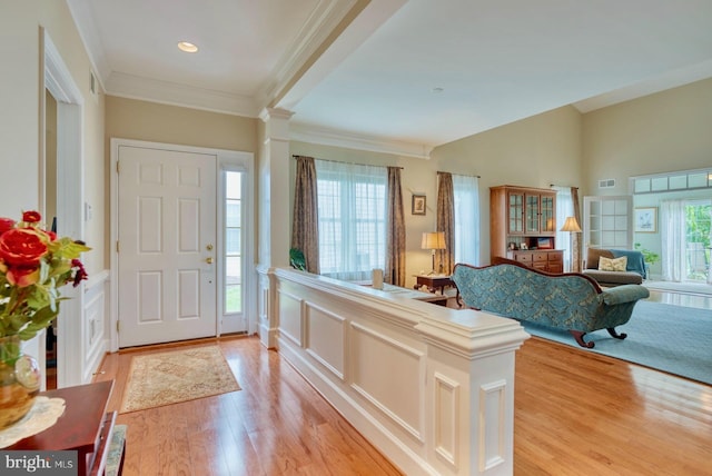 44458 Maltese Falcon Sq, Ashburn, VA 20147 - entryway with light wood-type flooring, ornate columns, crown molding, wainscoting, and recessed lighting