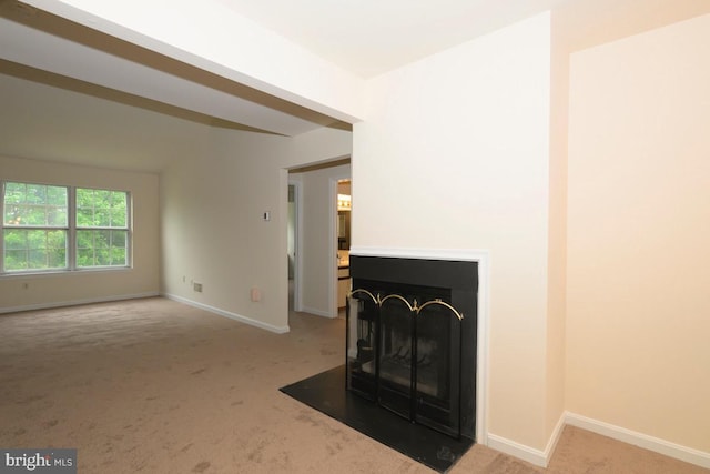 unfurnished living room featuring carpet flooring, a multi sided fireplace, and baseboards