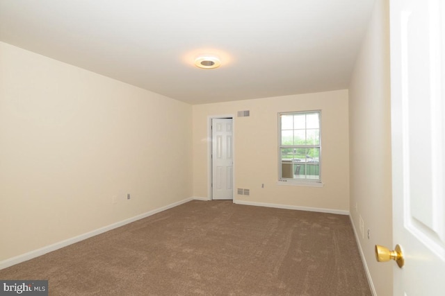 empty room with carpet flooring and baseboards