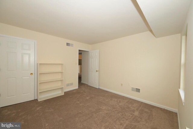 unfurnished bedroom with carpet flooring and baseboards
