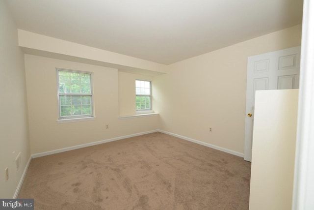empty room with carpet flooring and baseboards