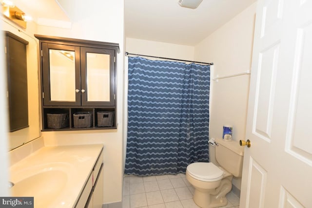 full bathroom with tile patterned floors, toilet, vanity, and curtained shower