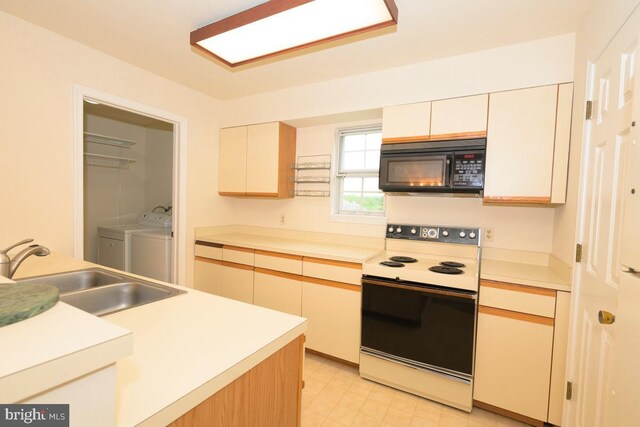 kitchen featuring black microwave, electric stove, a sink, washer and clothes dryer, and light countertops